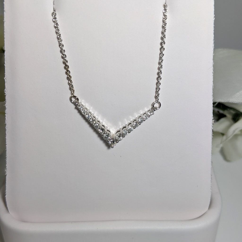 Constructed of 10K white gold and set with .38cttw in round brilliant cut diamonds this is a stunning piece that will wear well with jeans or that little black dress! Total length of necklace to tip of the V is 18" inches. $425.00