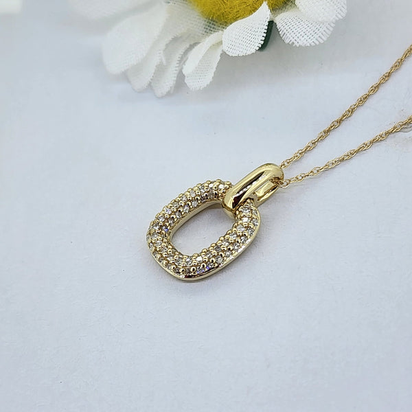 This beautiful pendant is made from 10K yellow gold and is set with 1/5th of a carat total weight in natural mined round brilliant cut diamonds. Including the high polish bail, this piece measures 16.26mm in length and 9.55mm in width. The pendant is hung on an 18 inch chain