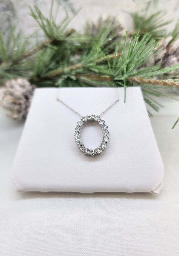 Made from 10k white gold, this lovely pendant is set with 1.00cttw in round brilliant cut lab diamonds. All sparkle and shine! The oval shape pendant measures just over 18mm in length. The pendant is hung from an 18" inch whisper chain