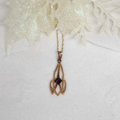 This lovely Lavalier is constructed of 10k yellow gold and set with a single 3mm purple stone. The pendant measures 25mm in length and 9mm in width. The pendant is hung on an 18" inch 14k yellow gold whisper chain