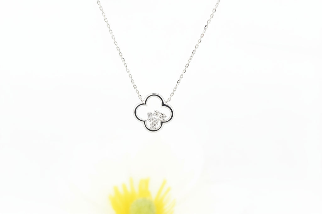 This modern clover pendant is crafted in 14k white gold with a sleek high-polish finish. The open clover design is accented with .06 carat total weight of natural mined diamonds, arranged in multiple diamond shapes that create a fresh, contemporary look with subtle sparkle.

The pendant measures 11.25mm and is attached to a 14k white gold adjustable cable chain, which adjusts to 16, 17, or 18 inches and secures with a lobster claw clasp