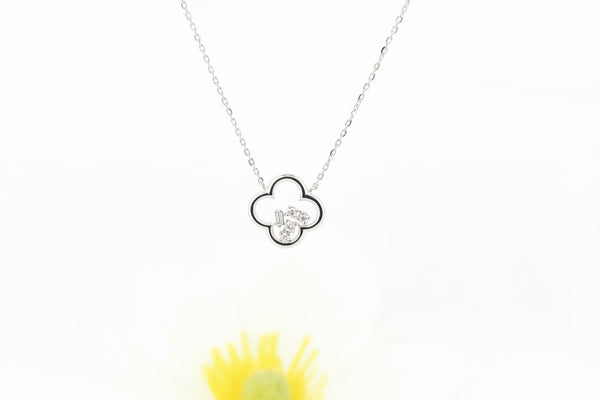 This modern clover pendant is crafted in 14k white gold with a sleek high-polish finish. The open clover design is accented with .06 carat total weight of natural mined diamonds, arranged in multiple diamond shapes that create a fresh, contemporary look with subtle sparkle.

The pendant measures 11.25mm and is attached to a 14k white gold adjustable cable chain, which adjusts to 16, 17, or 18 inches and secures with a lobster claw clasp