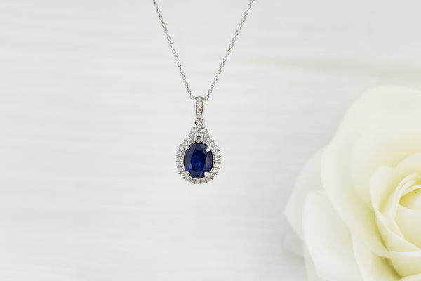 Stunning 14K White Gold 1.18ct natural oval blue Sapphire pendant! The blue of this Sapphire is just beautiful! Photo in natural sunlight included below. Accented with .25cttw in natural mined round brilliant cut diamonds enhance the already stunning beauty of this piece. The pendant measures 20.00mm in length and 10.62mm in length and is suspended on a 14k white gold 18 inch .80mm cable cha