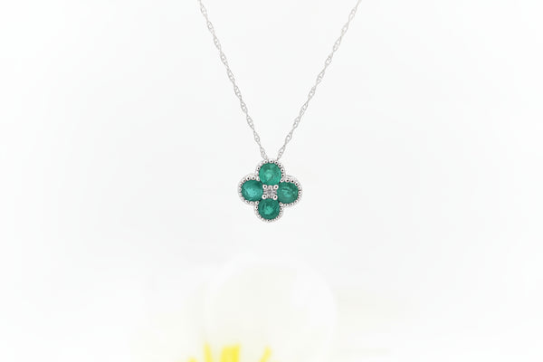 This elegant pendant is crafted in 14k white gold and features natural emeralds totaling .50 carat total weight, arranged in a graceful clover-inspired design. The rich green gemstones are accented by a .01 carat round brilliant cut natural mined diamond at the center, adding a subtle touch of sparkle.

The pendant is suspended from an 18-inch 14k white gold Singapore chain, offering a delicate shimmer and comfortable everyday wear.