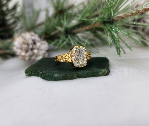 This lovely elongated cushion cut lab diamond ring is made from 14k yellow gold and is set with one 3.04ct lab grown diamond with an IGI report grading of E in color and VS1 in clarity. The milgrain top of the bezel set really adds some nice detail to this already stunning ring!&nbsp;