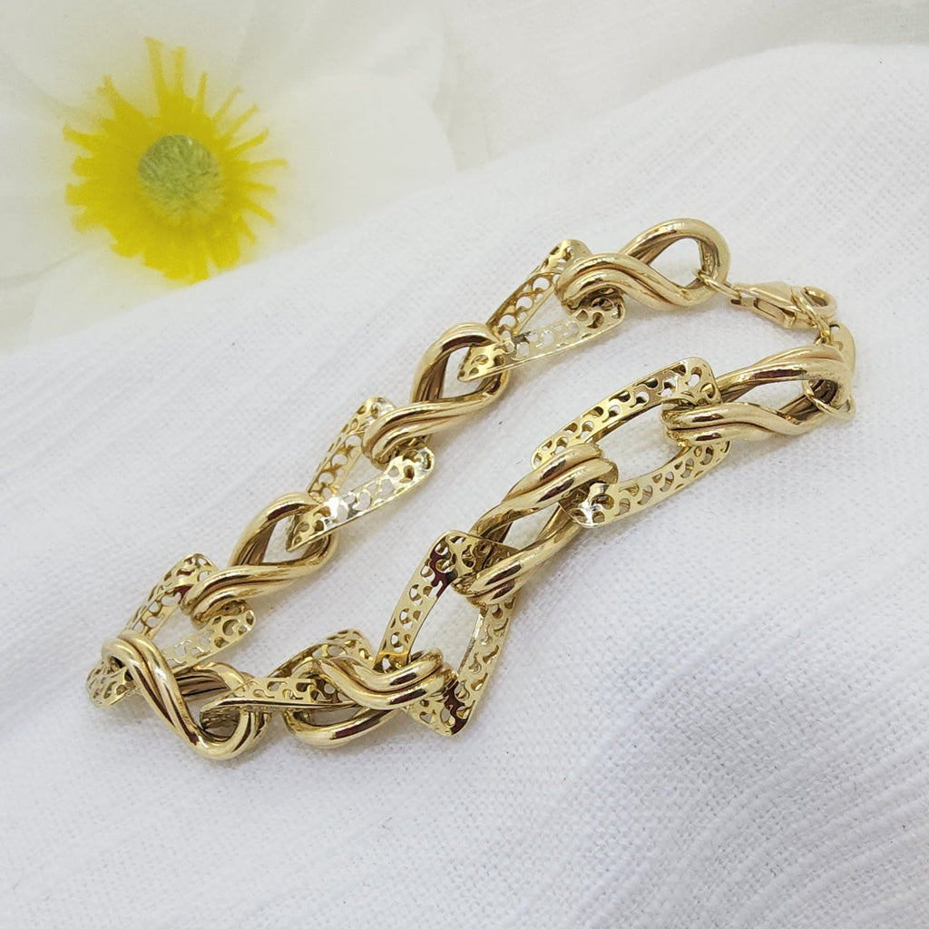This stunning 14K yellow gold bracelet showcases intricate craftsmanship with a unique alternating link design. Each high-polish twisted link is paired with an openwork decorative link, creating beautiful movement, texture, and visual interest throughout the bracelet.
The combination of solid gold twists and delicately patterned links gives this piece a refined yet distinctive look, making it perfect as a standalone statement or layered with other gold favorites. Finished with a secure lobster clasp 
