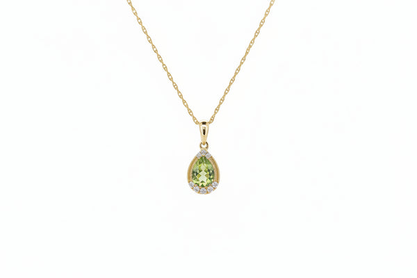 This delicate pendant is crafted in 14k yellow gold and features a natural pear-shaped peridot with vibrant green color. The center stone is accented by .09ctw carat total weight of natural mined diamonds, adding soft sparkle and refined contrast.
The pendant measures 15.30mm in length and 6.95mm in width and is suspended from an 18-inch 14k yellow gold chain. Its graceful silhouette and classic design make it perfect for everyday wear or layering.