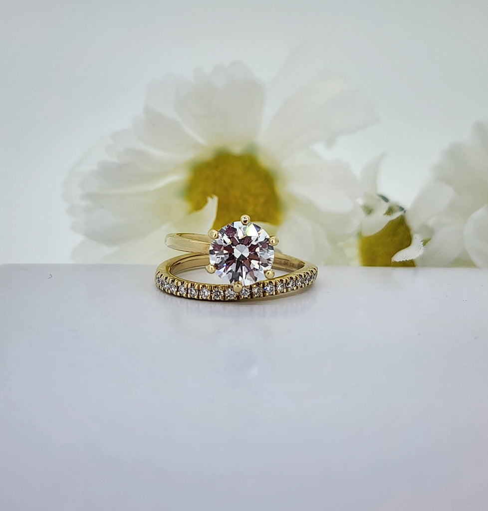 If you are looking for a unique ring, this is it! Could be an engagement ring/wedding set. Could be worn as a right hand fashion ring. This is one ring contemporarily designed to look like two rings. The center stone is a 2.00ct round brilliant cut Lab Created diamond that is D in color and VS1 in clarity. Below it is .25cttw in Lab Created diamonds