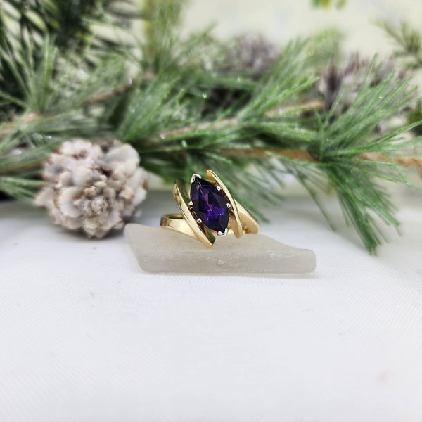 Very modern, nice and chunky 14k yellow gold Amethyst ring. The Amethyst measures 10mmx4.50mm and is set in a six prong white gold head. Beautiful design! Nice and heavy! The ring weighs 9.80grams and measures 11.63mm at the top and tapers to a 4.38mm at the shank.

*This is an estate item. Estate items have been refurbished but may show slight wear. Sizing not included
