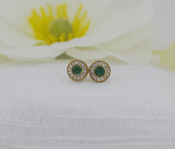 These classic stud earrings are crafted in 14k yellow gold and feature natural round faceted emeralds with a combined .19 carat total weight (measuring 2.60mm each). The vibrant green centers are framed by .09 carat total weight of natural mined diamonds, adding refined sparkle and contrast.
Designed with a regular post and medium friction backs, these earrings are comfortable and secure for wear.