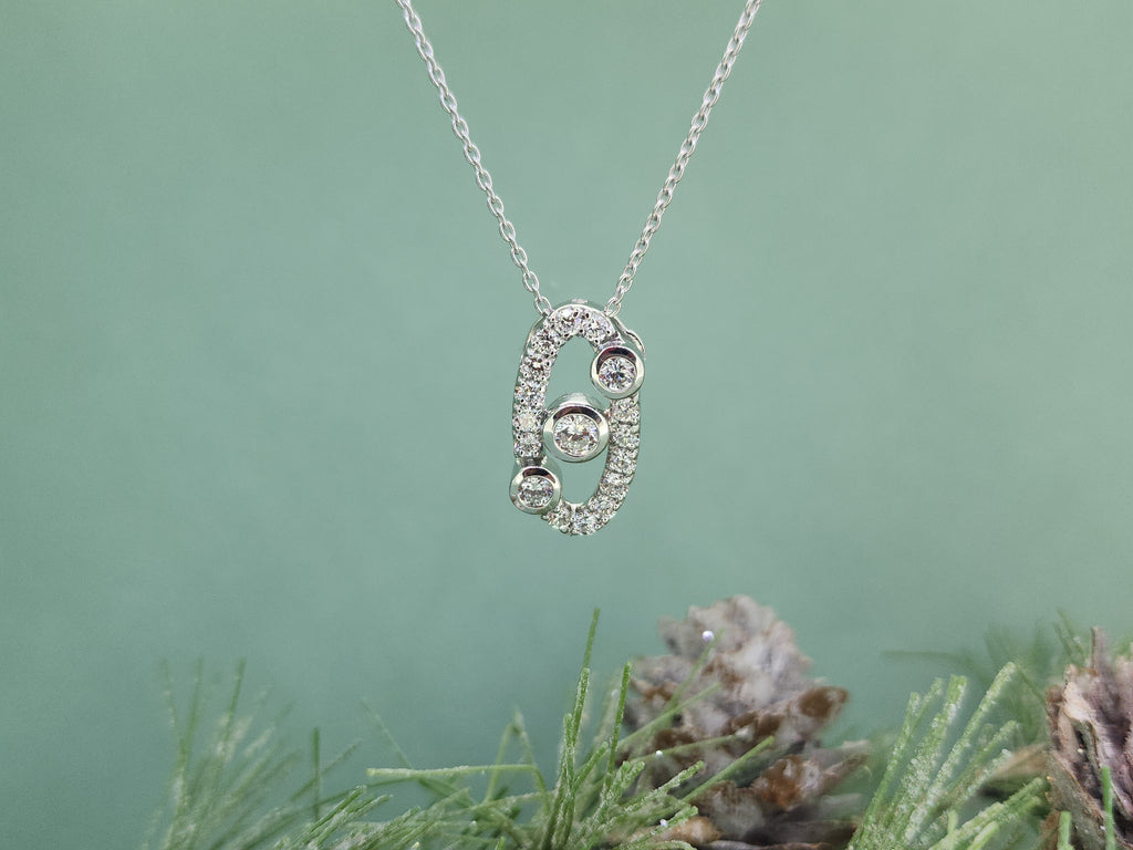 Crafted in luminous 925 sterling silver, this elegant necklace features a modern designed oval pendant accented with .75 carat total weight of created (lab) diamonds. The three larger diamond are set bezel set and are accented by pave set diamonds that offer a beautiful sparkle with a clean, contemporary look.

The pendant measures 18.33mm in length and 9.65mm in width and is suspended from an 18-inch sterling silver chain with a 2-inch extender, allowing for comfortable, adjustable wear. Refined yet versat