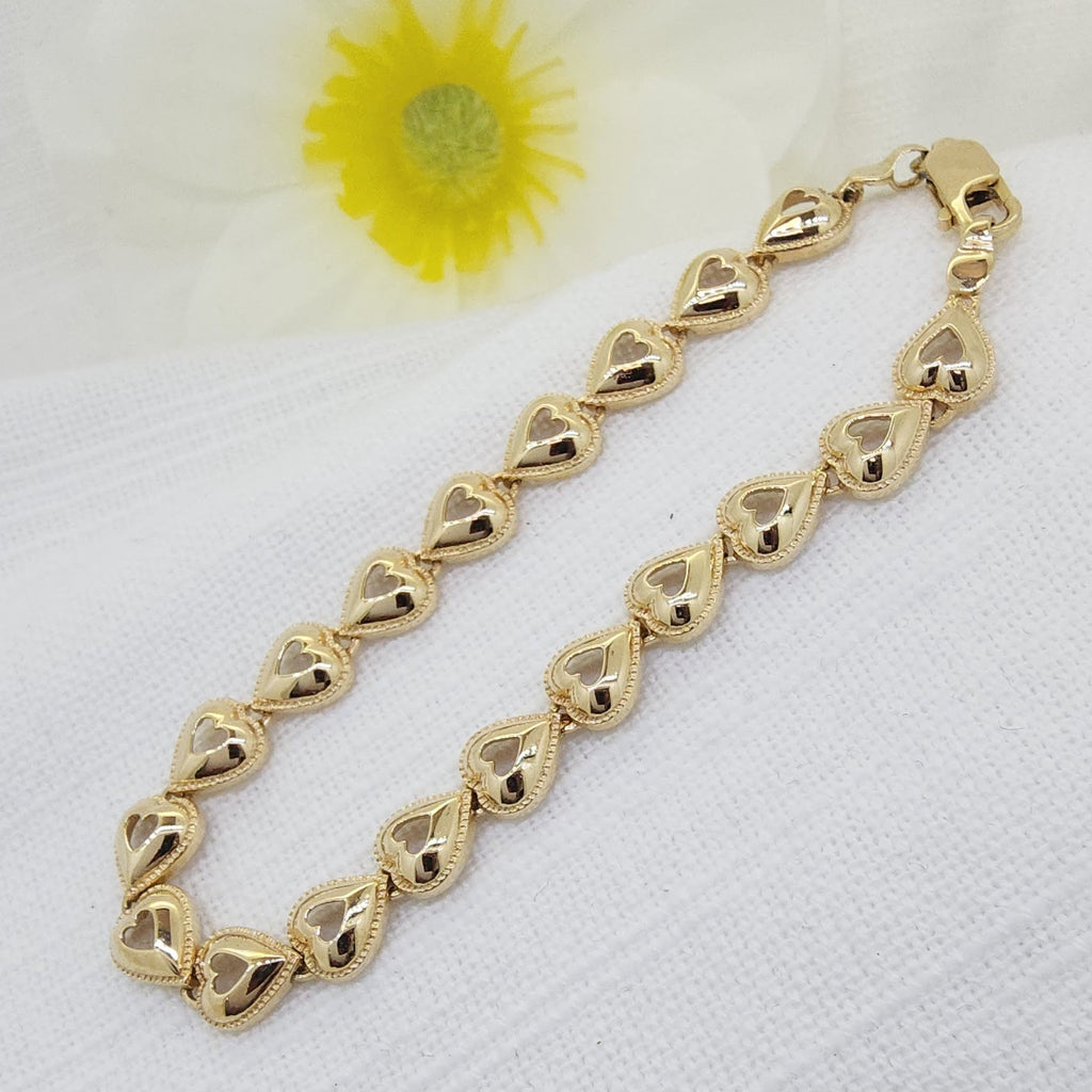 Delicate and meaningful, this 14K yellow gold open heart bracelet is a beautiful expression of love and elegance. Each polished heart link features a graceful open-center design, accented with a fine beaded milgrain-style detail that adds texture and vintage-inspired charm.
The bracelet’s warm yellow gold glow and feminine heart motif make it perfect for everyday wear. Finished with a secure lobster clasp  