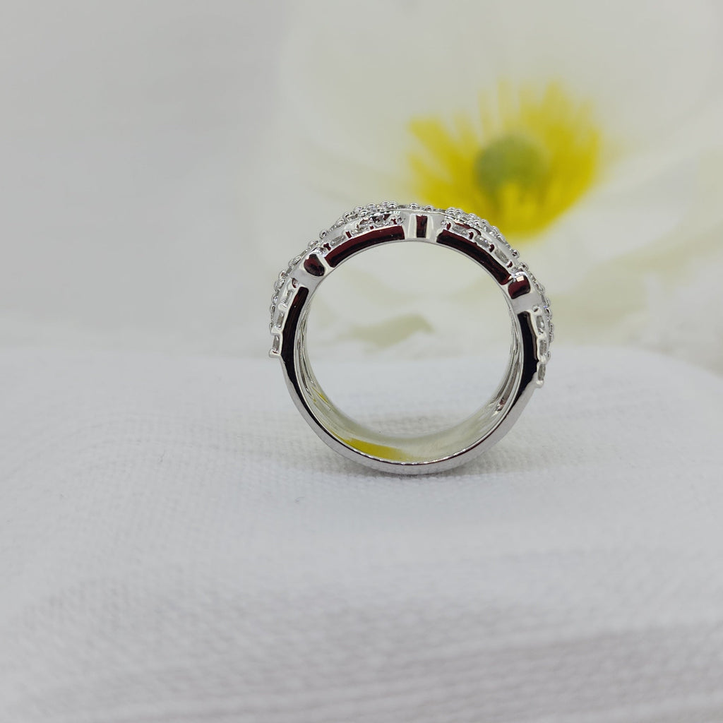 This bold 925 sterling silver statement ring is set with an impressive 1.35 carat total weight of Created (lab) diamonds, all round brilliant cut for exceptional sparkle and fire. The wide band design showcases intricate diamond detailing, creating a luxurious look with substantial presence on the hand.

Measuring 11.57mm at the top and tapering slightly to a 10.19mm shank, this ring is designed to stand beautifully on its own while offering a comfortable, confident fit. A striking choice for those who love