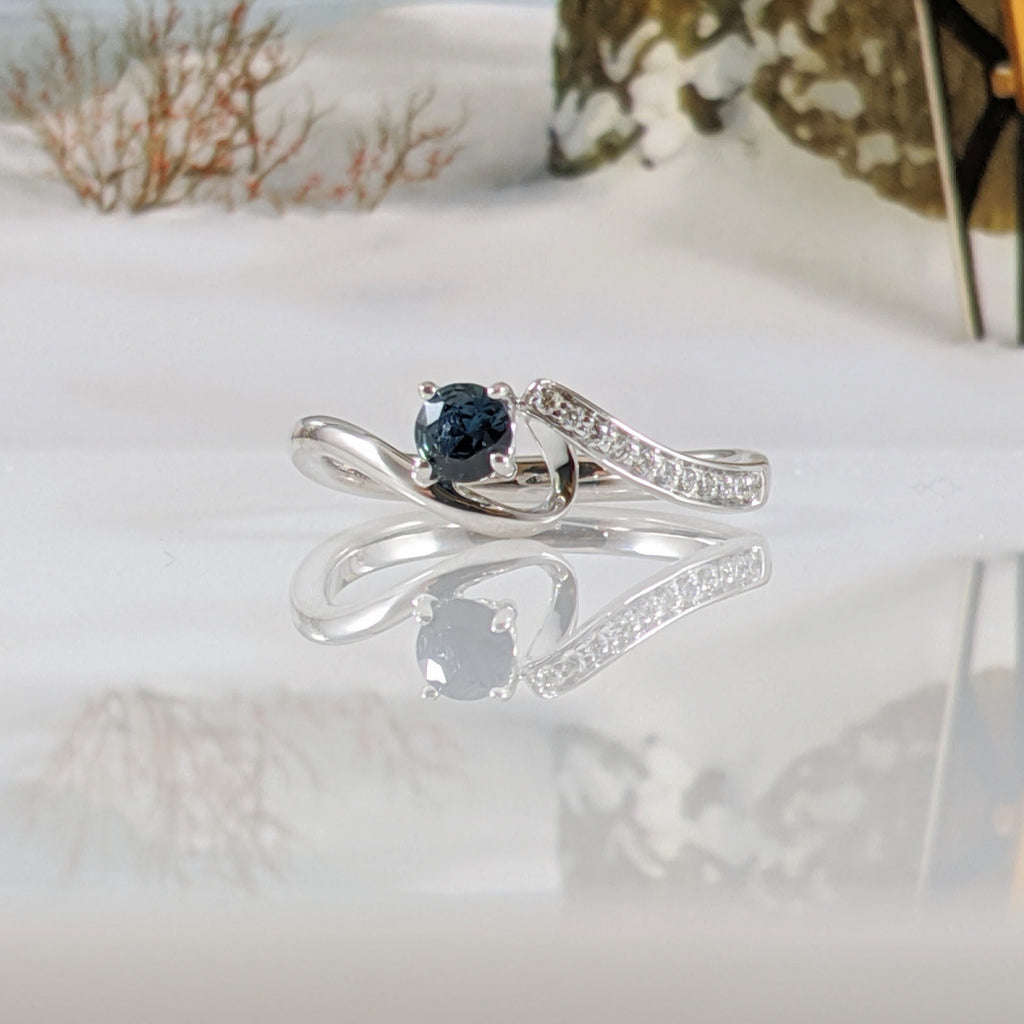 10K white gold and diamond natural blue sapphire ring set with .06cttw in round brilliant cut diamonds. Finger size 6.75. $980.00