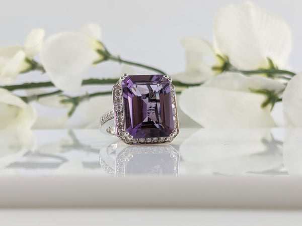 Gorgeous 14K white gold and Amethyst diamond ring. Center stone is a 15.80mm by 11.94mm emerald cut Amethyst with an additional .64cttw in diamonds. Finger size 6.5.  $1375.00
