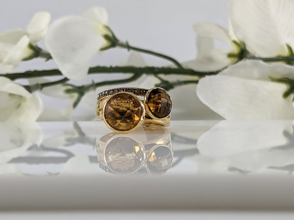 Very unique and bold ring. The citrine measures 10mm and shines next to the deep cognac brown of the quartz. This was part of an estate so shows some love it received in it's former life :)  $350.00 Finger size 7