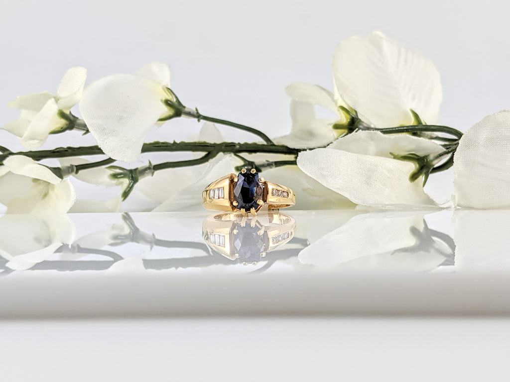 This 14k yellow gold ring features a lovely 9x6.43mm Spinel set with .15cttw in round and baguette cut diamonds. Unique design. Finger size 7.25. $1970.00