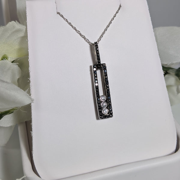 Black and white goes with just about every outfit! This stunning diamond pendant contains .30cttw in black and white diamonds. Lots of shine and sparkle from this beauty! Pendant measures just over 31mm in length and comes with the chain 10k white gold light 18" inches. $475.00