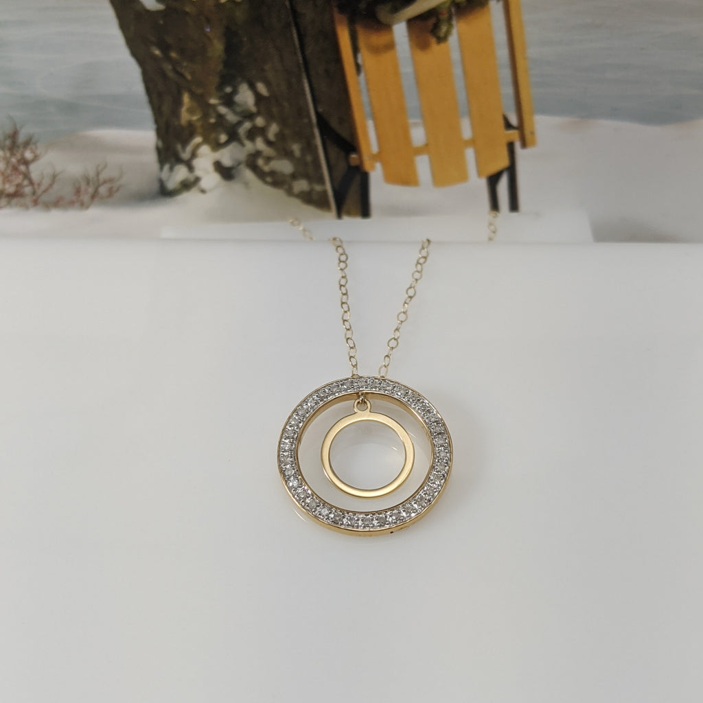 The pendant mounting is constructed of 10k yellow gold and contains .12cttw in round brilliant cut diamonds. Pendant is hung on an 18 inch light link chain. $275.00