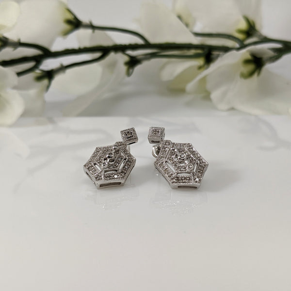 Stunning 14K white gold and diamond vintage inspired Earrings!  .30cttw in round brilliant cut diamonds sparkle and draw the eye to this lovely earrings. Standard white gold posts and back. Matching pendant available. Earrings $500.00
