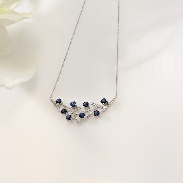Unique design featuring eight beautiful natural blue sapphires and almost a quarter of a carat in diamonds. Necklace hangs just shy of 18" inches. Such a lovely piece. $660.00