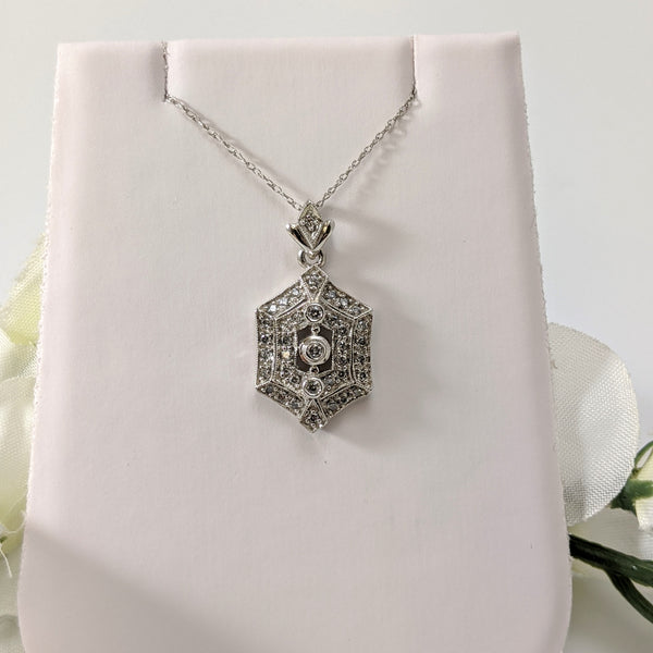 Stunning 14K white gold and diamond vintage inspired pendant!  .30cttw in round brilliant cut diamonds sparkle and draw the eye to this lovely pendant. Hung on an 18" inch 14k light white gold chain. Only $450.00!