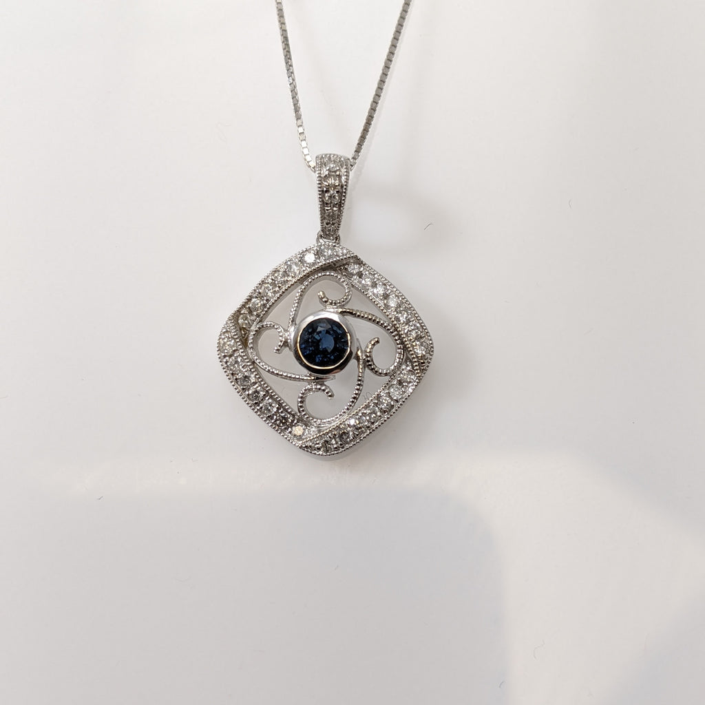 Vintage inspired, this lovely pendant is set with a 420mm round natural blue Sapphire. The Sapphire is a vibrant blue that is really showcased by the white gold and the .20cttw in round brilliant cut diamonds. Chain sold separately. $1125.00