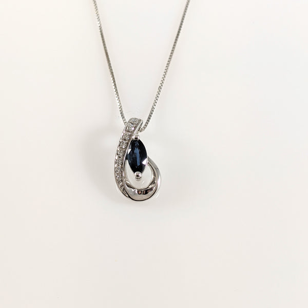 Pendant holds a 6x3mm marquise cut blue Sapphire and .04cttw in round brilliant cut diamonds. Pendant measures 13.85mm in length. Chain sold separately. $375.00
